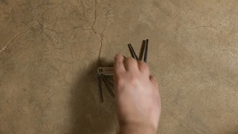 Tools being placed in frame on concrete Stock Footage 121010604