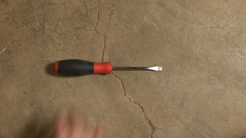 Tools being placed in frame on concrete Stock Footage 121010995