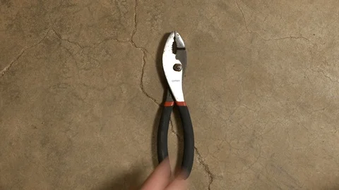 Tools being placed in frame on concrete Stock Footage 121011627