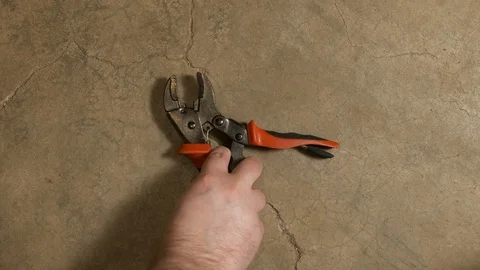 Tools being placed in frame on concrete Stock Footage 121012284