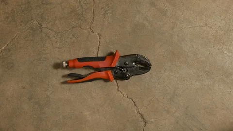 Tools being placed in frame on concrete Stock Footage 121012348