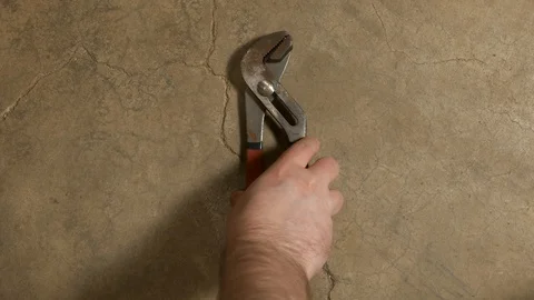 Tools being placed in frame on concrete Stock Footage 121012670