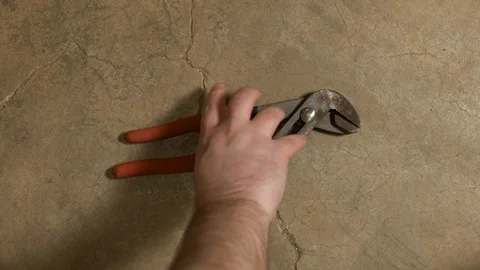 Tools being placed in frame on concrete Stock Footage 121012705