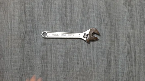 Tools being placed in frame by hand with grey wood texture backdrop Stock Footage 121004719