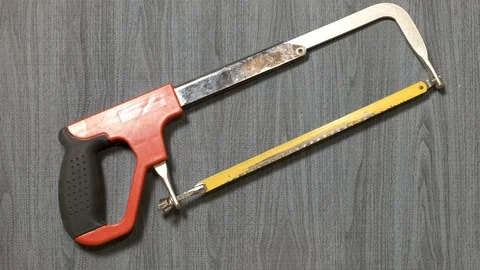 Tools being placed in frame by hand with grey wood texture backdrop Stock Footage 121006028