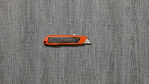 Tools being placed in frame by hand with grey wood texture backdrop Stock Footage 121006179