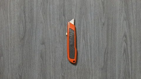 Tools being placed in frame by hand with grey wood texture backdrop Stock Footage 121006190