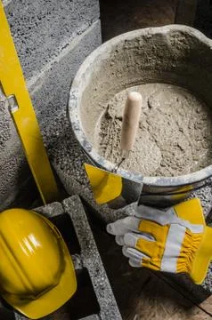 Tools for bricklayer bucket with a solution and a trowel, close-up Stock Photos