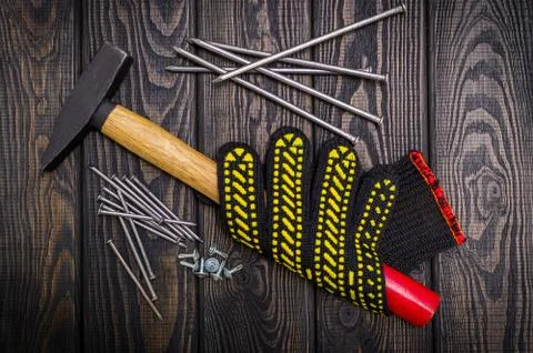 Tools for carpentry and accessories on a black wood background. Stock Photos