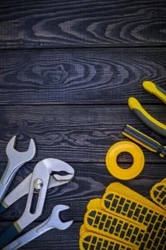 Tools for carpentry and accessories on a black wood background. Stock Photos