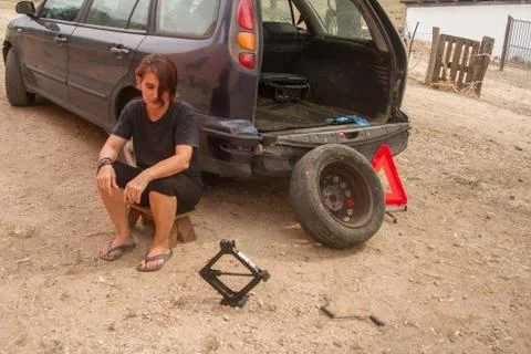 Tools to change car tires using jack with a  beautiful woman Stock Photos