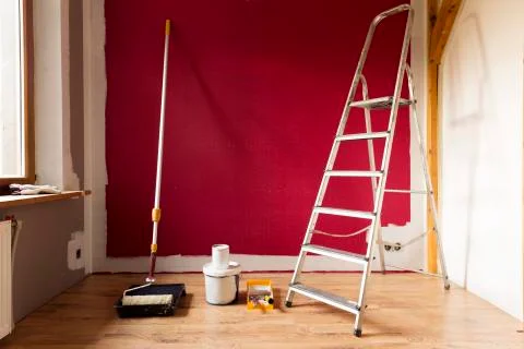 Tools for coloring, paint roller, brush, aluminium leader. Wall partly collor Stock Photos