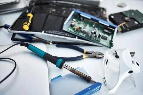 Tools, computer hardware and equipment in the office for tech repairs Stock Photos