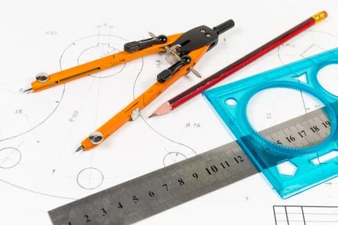Tools for draftsmanship on a training drawing close-up Stock Photos