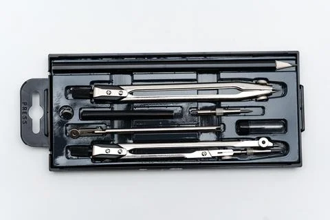 Tools for drawing circles and lines in a metal box on a white background Foto stock