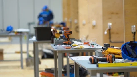 Tools, drills, pliers left by workers at factory placed on tables or workbenches Stock Footage 126357611