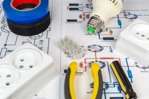 Tools for electricians and sockets on the grey surface. Stock Photos