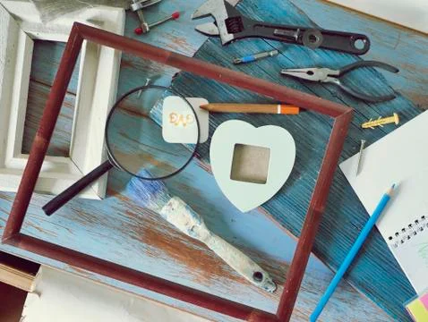 Tools, frame, notebook, congratulation on a wooden table, top view, father's day Stock Photos