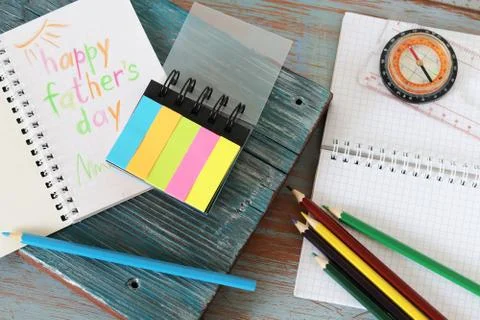 Tools, frame, notebook, congratulation on a wooden table, top view, father's day Stock Photos