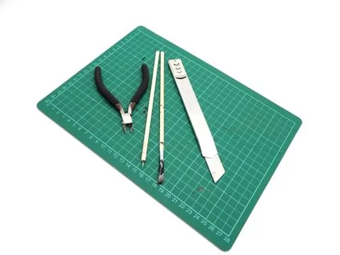 Tools with green cutting mat for model kit isolated on white background. Stock Photos