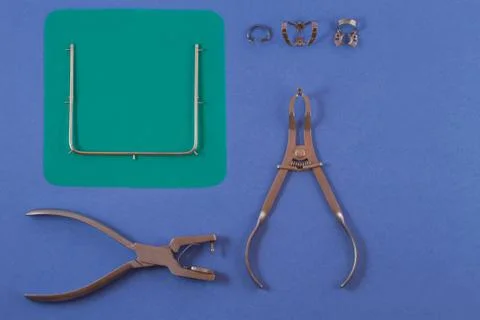 Tools for installing the cofferdam lying on a blue background. Stock Photos