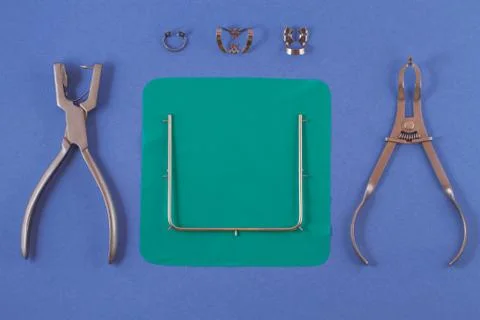 Tools for installing the cofferdam lying on a blue background. Stock Photos