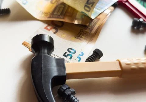 Tools lying over banknotes background Stock Photos