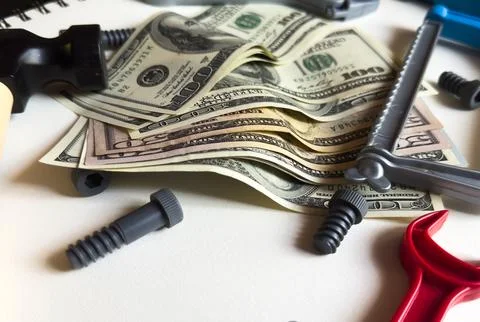 Tools lying over banknotes background Stock Photos