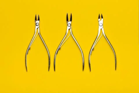 Tools of a manicure scissors on a yellow background Stock Photos