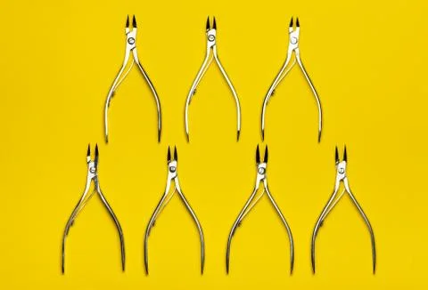 Tools of a manicure scissors on a yellow background Stock Photos