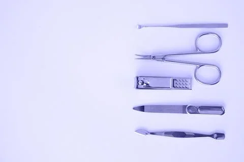 Tools of a manicure set on a light background. photo toned in the color of th Stock Photos