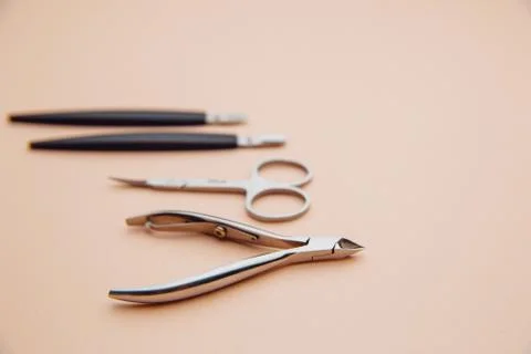Tools of a manicure set on a pink table. Nail care concept Stock Photos