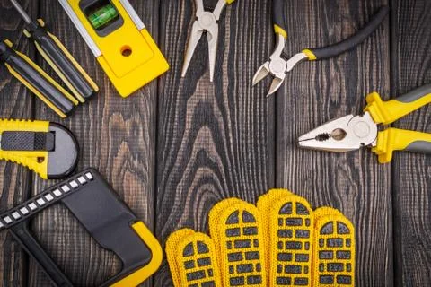 Tools for master builder and accessories on a wooden black vintage background Stock Photos