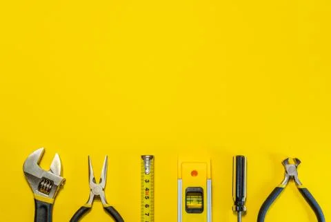 Tools for master builder and accessories on yellow background Stock Photos