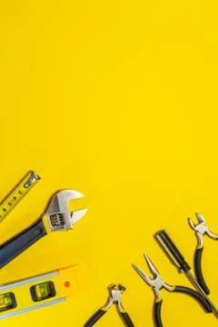 Tools for master builder and accessories on yellow background Stock Photos