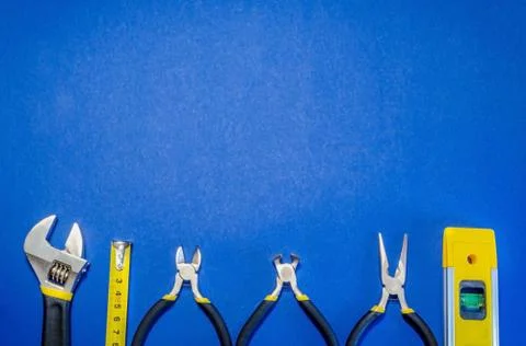 Tools for master builder and accessories on blue background Stock Photos