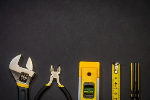Tools for master builder and accessories on a black background Stock Photos
