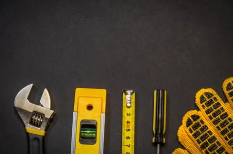 Tools for master builder and accessories on a black background Stock Photos