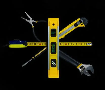 Tools for master builder on a black background. Close-up of construction tool Stock Photos