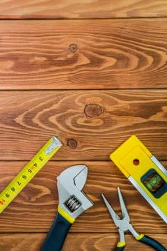 Tools for master builder prepared before work on a brown wooden boards Stock Photos