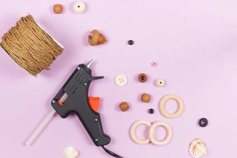 Tools for needlework, crafts and creativity. Glue gun, wooden beads, buttons Stock Photos