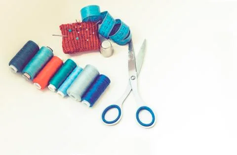 Tools for needlework, red knitted needle pad for sewing, scissors and colored Stock Photos