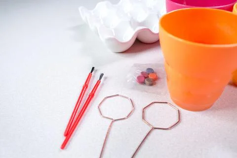 Tools for painting eggs for easter, eggs box, easter eggs, plate, brushes and Stock Photos