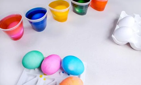 Tools for painting eggs for easter, eggs box, cups of colorful paint, easter Stock Photos