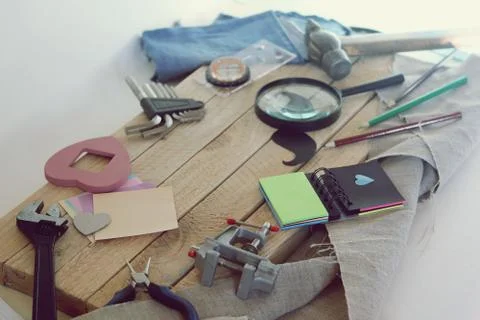 Tools, paper mustache, notepad, congratulation on a wooden table, top view Stock Photos