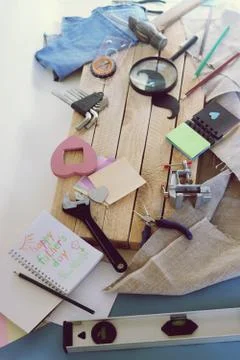 Tools, paper mustache, notepad, congratulation on a wooden table, top view Stock Photos