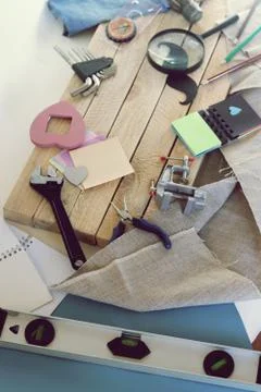 Tools, paper mustache, notepad, congratulation on a wooden table, top view Stock Photos