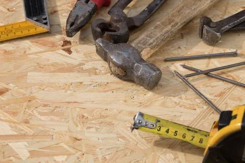 Tools set on osb panel with copy space. Carpenter workplace on wooden background Stock Photos