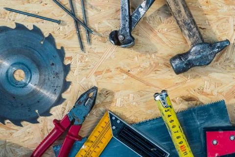 Tools set on osb panel with copy space. Carpenter workplace on wooden background Stock Photos