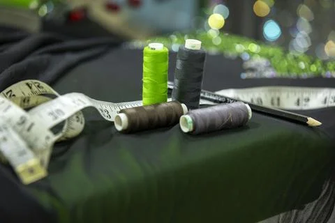 Tools of sewing. sewing thread rolls, centimetre, scissors, tap measures Stock Photos